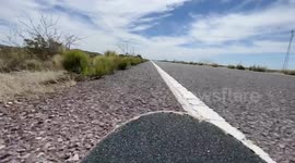 POV footage of a skateboard rolling on some rough ground from cross country trip