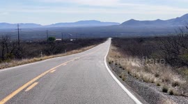 Scenic shot of a long road going towards some mountains in Arizona