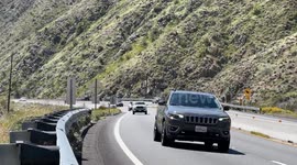 Mountain-side highway footage of route 62 from Palm Springs CA towards Joshua Tree, CA