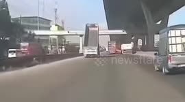 Truck with tipper bed raised crashes into footbridge causing collapse