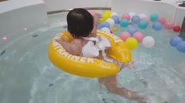 One-Year-Old Baby Swims Calmly Alone in Big Aquarium at Baby Spa