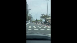 Man Pilots Walking Robot Across Pedestrian Crossing