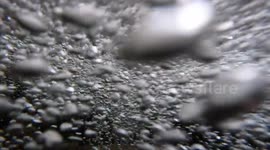 Hypnotic Slow-Motion Underwater Bubble Dance in Mountain River. Bubbles elongate, twist, and snap back to perfect spheres. A mesmerizing real-time demonstration of Pure Surface Tension Physics and fluid dynamics.