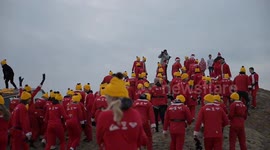 Hundreds of 'Surfin’ Santas' brave North Sea waves in Dutch Christmas tradition