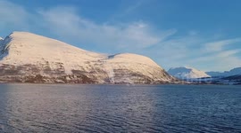 Raw footage from a boat travelling through the Norwegian Arctic Cercle. Crystal-clear open Arctic waters (no floating ice), natural spring thawing, and a clear sky. Authentic strong polar wind sound throughout.