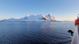 Arctic Boat Journey (Norway) Rare Banded Sunset Glitter on Sea with Melting Ice Peak. Stunning raw footage. Sunset light creates rare structured “binary-like