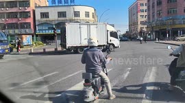 Huge truck carries even larger load, almost tripling its size on Chinese road