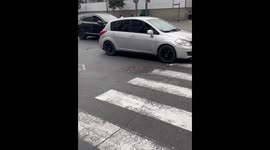 Woman drives child-sized electric car on busy highway in Lima, Peru