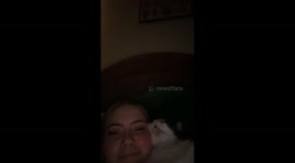 Cat makes bubbly snoring sounds while sleeping next to owner in Leeds, UK