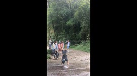 Man crosses shallow river while performing handstand in Kathmandu, Nepal