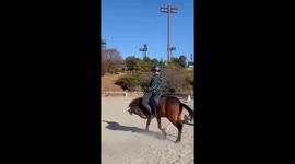 Man awkwardly loses balance while riding a horse in Beijing, China