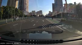 Scooter collides with car at busy intersection in Jiangsu, China