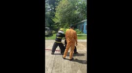 Youngster knocked over by the force of fire hose in training exercise