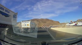 White Sedan Merging Onto Highway Crashes Into Soil Truck