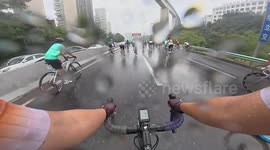 Cyclists crash on wet road during rain-soaked bike race
