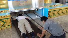Visitors Squeeze Inside the Sacred Heart of the Reclining Buddha at Wat Thada Pracharam, Thailand