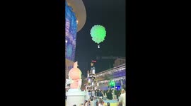Performer dangles from balloons for 'space ballet' performance