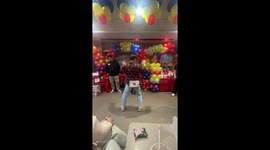 Energetic man play hilarious party game shaking backside to remove balls