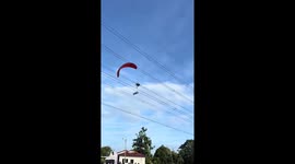 Paramotor pilot crashes into overhead power lines and plunges into field