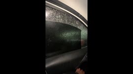 Driver rolls down window to find layer of ice still in place