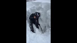 Man digs out car after overnight snowfall in Kamchatka, Russia