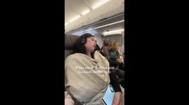 Passenger naps with “Chicken” sign to secure in‑flight meal—TikTok clip hits 45.7M views