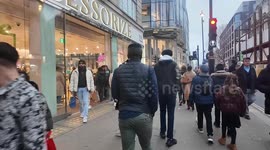 Last minute shoppers hit Oxford Street in London looking for gifts on Christmas Eve