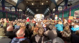Crowds wave cash in air as they bid on turkeys for Christmas at Smithfield market