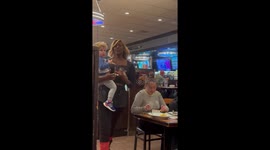 Waitress Comforts Crying Toddler While Serving Tables