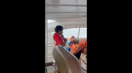 Indian tourists dance as they enjoy speedboat to Thai island