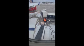 Airplane Luggage Keeps Sliding Down Icy Conveyor Belt