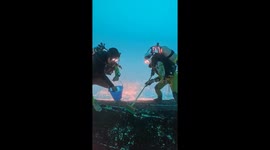 Divers Clean Boat Upside-Down