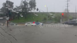 US: Rain-Lashed Streets Swallow Vehicles During Severe Storm In San Fernando Valley