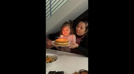 Toddler hilariously battles single birthday candle at family dinner—Instagram clip hits 280K views