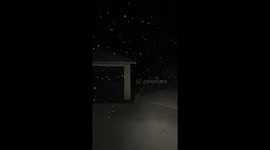 Nighttime snowfall creates snow globe effect in Boston, Massachusetts, USA