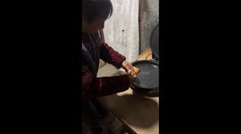 Grandma struggles with fake egg while cooking, Shaanxi, China