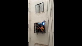 Resident napping on 10th floor window ledge falls off but lands on grills below