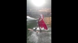 Schoolgirl in red cape and Santa hat shows off impressive wakeboarding skills