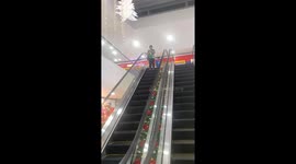 Woman Distracted By Receipt Doesn't Move On Broken Escalator