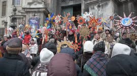 Residents carry Christmas stars during procession in Lviv