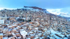 DRONE - Snow blankets Türkiye's historic Mardin, creating picturesque winter tableau