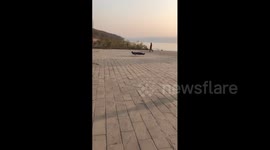 China: Man appears to float above ground on wire in China