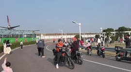 Plane spotters struggle to stay upright as departing jet blast hits crowd