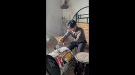 Solo drummer plays through smoke and sparks as firework erupts