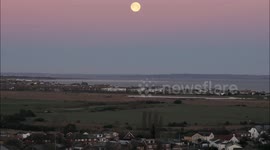 Spectacular Wolf Supermoon seen setting over the Thames Estuary off Kent, UK