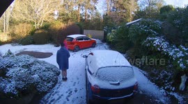 Close call caught on camera as car slides back on icy driveway in UK