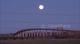Wolf Supermoon seen rising over the Sheppey Crossing in Kent, UK