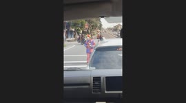 Street Clown Entertains Crowds in Busy Jogja City Road