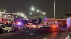Police vehicles with lights flashing wait outside the Metropolitan Detention Center during Maduro arrival