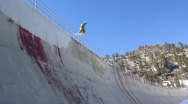 Skier hit rail slide and exits down on to a Huge Hidden Dam